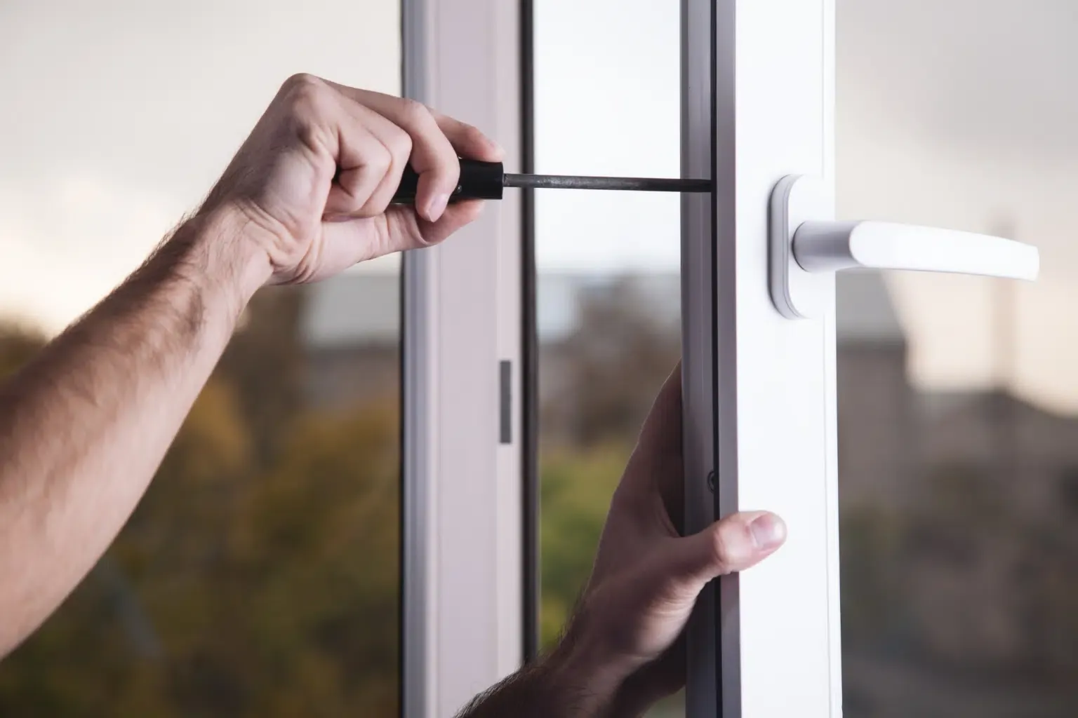 A picture of a hand trying to replace a window.